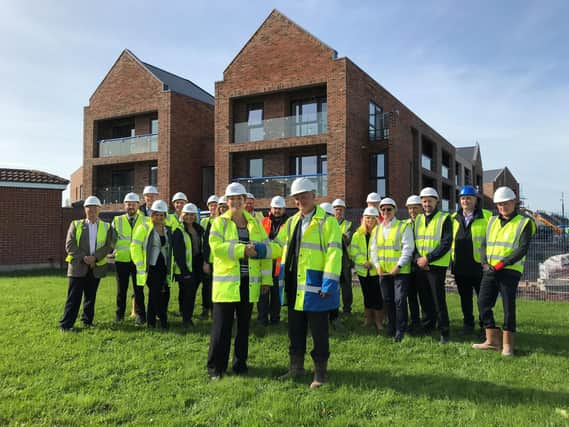Staff from construction firm Bardsleys celebrate the 'topping out' ceremony at Lighthouse View last September, but in December the company went into administration