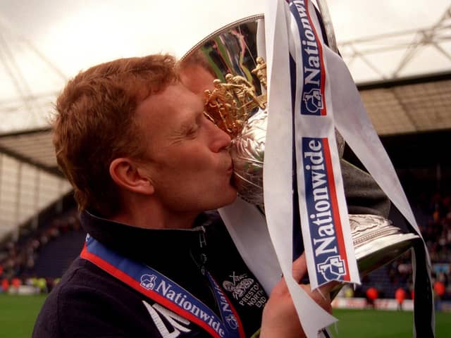 Preston North End manager David Moyes plants a kiss on the Division Two Championship trophy as the team clinched promotion