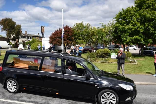 The funeral cortege of Keith Shuck passes through Staining as people line the streets