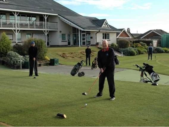 Dave Mahon prepares to strike the first drive after lockdown at Knott End Golf Club
