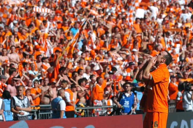 Blackpool captain Charlie Adam celebrates with the fans at Wembley