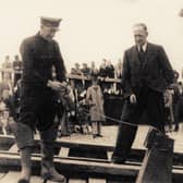 Coxswain Jeffery Wright and Second Coxswain James Leadbetter demonstrating firing of the maroons at a lifeboat day in the late 1940s.