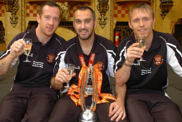 Gary Taylor-Fletcher with the Championship play-off trophy flanked by fellow Wembley goalscorers Charlie Adam (left) and Brett Ormerod