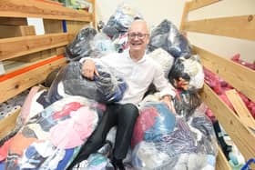 Paul Guest, Trinity and Brian Houses head of retail, with a pile of the contributions