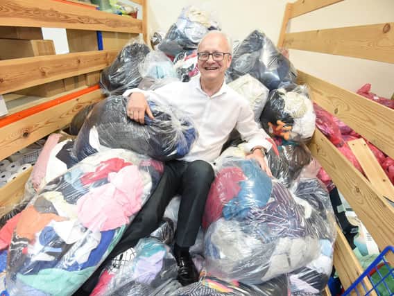 Paul Guest, Trinity and Brian Houses head of retail, with a pile of the contributions