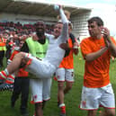 Barry Bannan gets a lift from Jason Euell as Blackpool celebrate qualifying for the play-offs