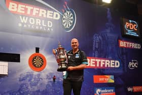 Reigning Betfred World Matchplay champion Rob Cross with the trophy at the Winter Gardens Picture: CHRIS DEAN/PDC