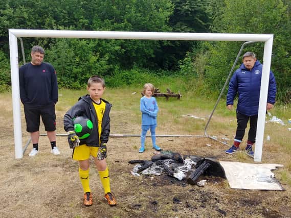 Lytham Town first team manager Chris Best (left) and academy manager Lee Mitchell inspect the damage with eight-year-old players Lewis Ames (in yellow) and Reggie Sharples
