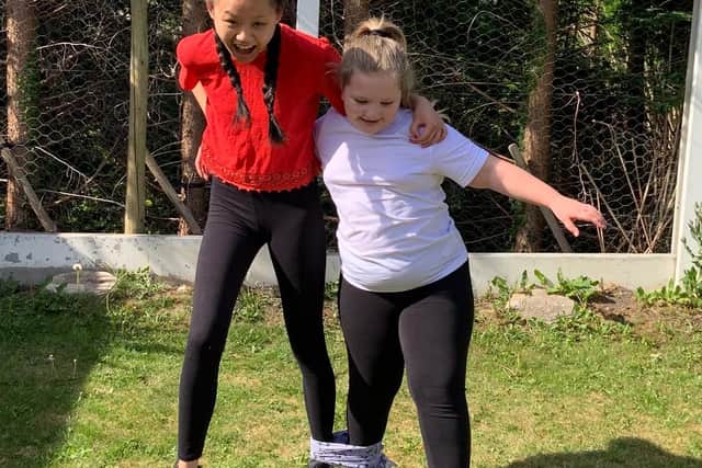 Alyssa Davies with sister Lauren training for a Cancer Research school sports day in their garden