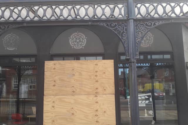 A smashed window at Fleetwood Library is boarded up