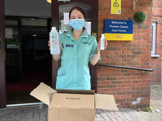 Receiving the UCLan-made  sanitiser at Preston Grange