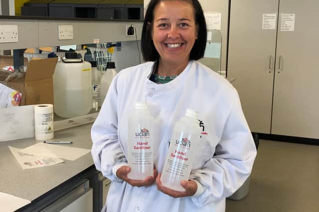 Technician Terri Blohm with the labelled bottles of hand sanitiser