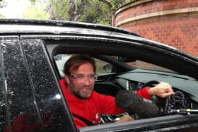 Liverpool boss Jurgen Klopp can't avoid the microphones at home in Formby today