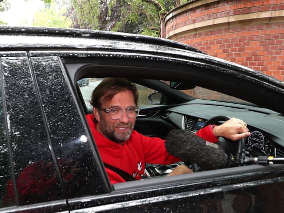 Liverpool boss Jurgen Klopp can't avoid the microphones at home in Formby today