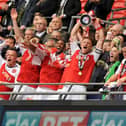 Fleetwood captain Mark Roberts lifts the League Two Play-off trophy at Wembley in 2014