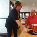 Landlady Kerry Humphries serves a customer at The Mitre