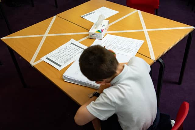 Social distancing measures as a child studies on a marked table