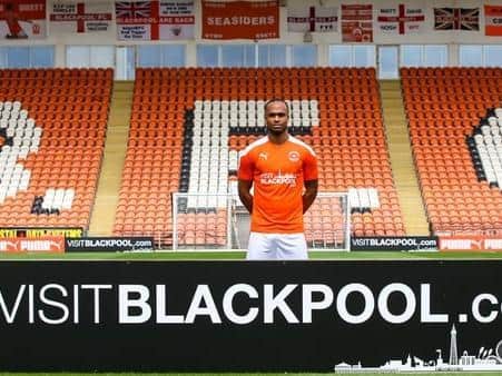 Nathan Delfouneso models the new Blackpool kit with the Visit Blackpool branding