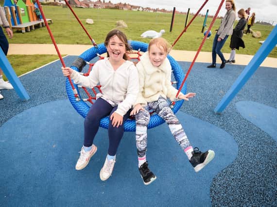 Alice Tenbey, eight, and Annabela Andrews, 10, enjoy the new pirate-themed swing.
