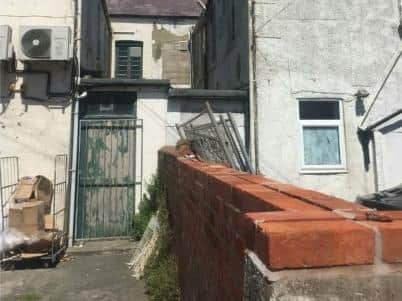 One of the photos submitted with the application for new apartments at a former cafe on Victoria Road West, Cleveleys described a yard "in need of repair."