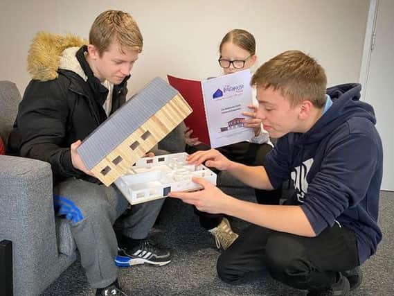 Young people with a scale model of the proposed Fleetwood centre