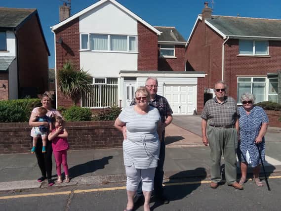 Some of the residents who are protesting, from left Ellie Monkman with her children Lexi and Blake, Andrew and Deborah Foley and Gordon and Terry Thomas, outside the property earmarked to become a children's home.