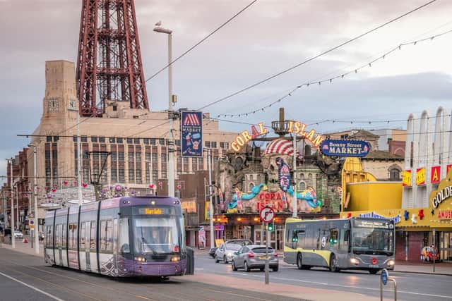A Blackpool Transport bus and tram on the promenade. The company is cutting fares on both its trams and buses from Sunday