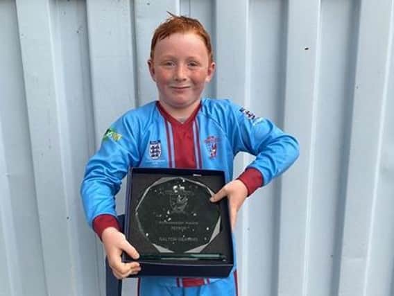 Dalton Gearing, nine, won the Layton Juniors Ambassador Award for his fundraising efforts for Blue Skies