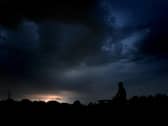 A man watches Monday night's thunderstorm from Buckshaw Village in Lancashire