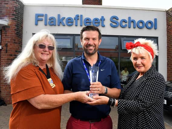 Flakefleet head teacher, Dave McPartlin, is presented with Fleetwood Town Council's inaugural Community Excellence Award by Coun Mary Stirzaker and Coun Lorraine Beavers