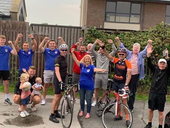 John Maguire (front right) earned the praise and thanks of all at Squirs Gate FC for his 100-mile cycling feat