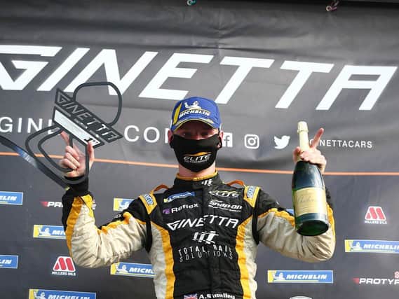Ginetta G55 racer Adam Poulton on the winner's podium at Brands Hatch Picture: JAKOB EBREY PHOTOGRAPHY