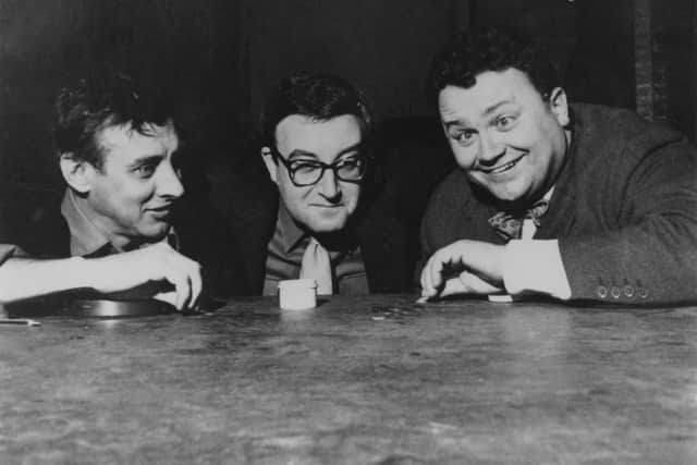 Spike Milligan, Peter Sellers and Harry Secombe of British radio comedy The Goon Show prepare for a tiddlywinks contest, 1958