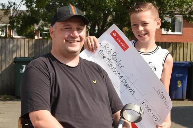 Rob Ryder with Kai and the cheque for 1,000