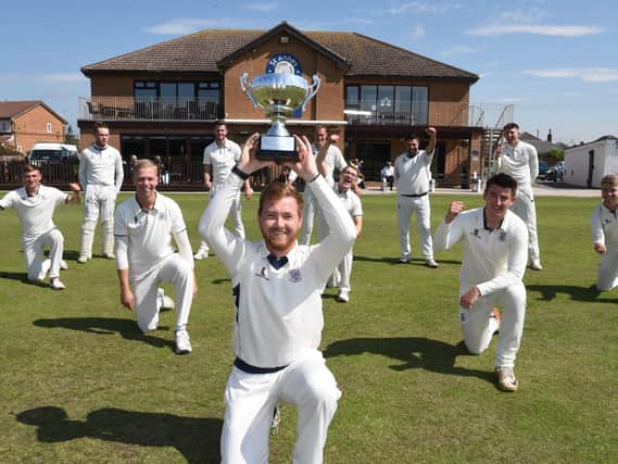 St Annes Cricket Club captain Tom Higson holds aloft The Gazette Trophy won against Lytham, one of their four straight victories over Fylde coast rivals in the elite group of the 40-over competition