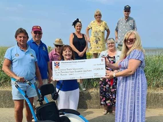 Fleetwood Town Council chairman, Coun Mary Stirzaker (right) hands over a cheque for Mick Gray (left) of Fleetwood Beach Wheelchair group. Photo: ‘Ravenswood Photography