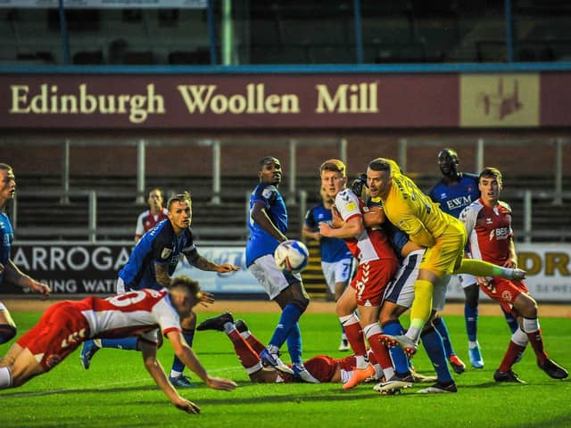 A diving Harvey Saunders puts Fleetwood Town ahead with the first of his two goals at Carlisle   Picture: STEPHEN BUCKLEY / PRiME MEDIA IMAGES