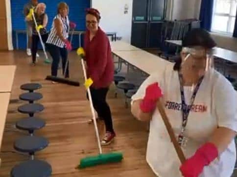 Clean sweep - members of staff at Flakefleet Primary School in the Back to School video