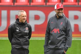 Neil Critchley with Liverpool boss Jurgen Klopp before kick-off