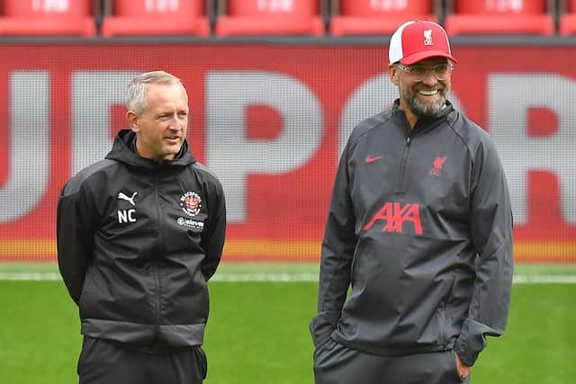 Neil Critchley pictured with Liverpool boss Jurgen Klopp at Anfield on Saturday