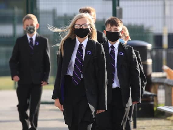 Children head to school wearing face masks