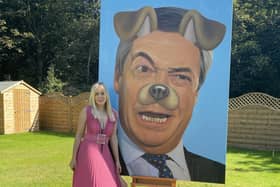 Artist Lucy Morris with her distinctive painting of Nigel Farage