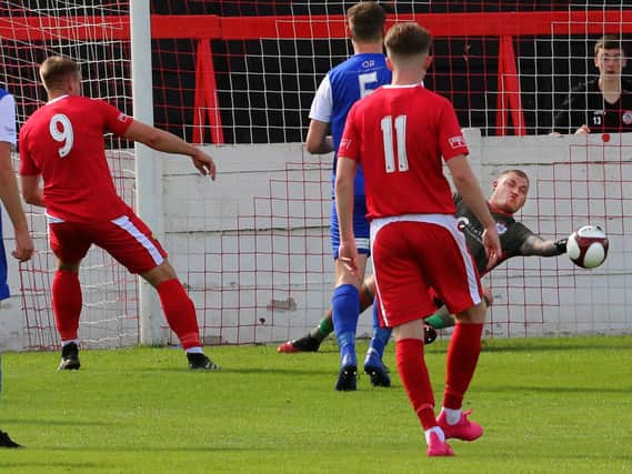 Jordan Gidley pulls off a point-blank save for Squires Gate at Ashton United