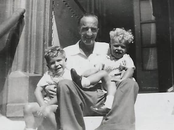 Ray and Roy Toddington with their dad George, sat on the steps of the boarding house, affectionately named Auntie Bettie's