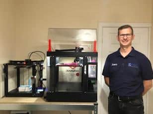 Sam Schmierer with on of the 3D printing machines