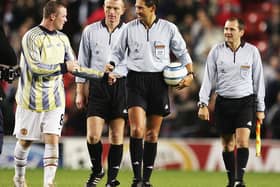 Wayne Rooney tries to get the matchball from the referee after a hat-trick on his debut during the Champions League Group D match between Manchester United and Fenerbahce at Old Trafford on September 28, 2004