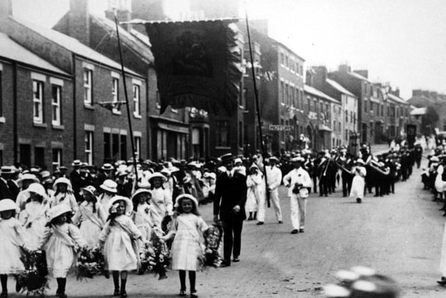 Kirkham and Wesham Club day procession - early 1900s - along Poulton Street, Kirkham, led by little flower girls, with brass band in background