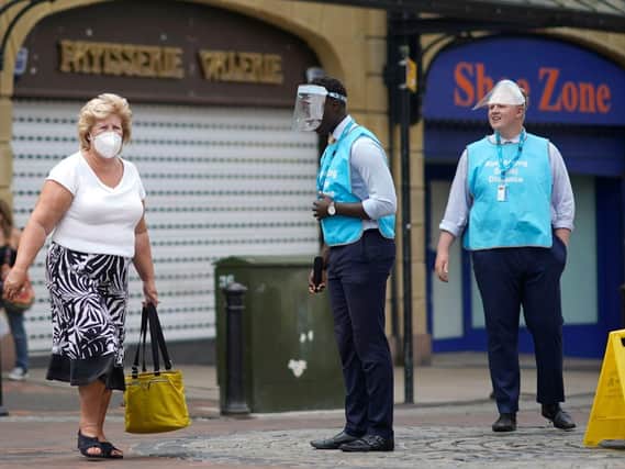Scammers posing as coronavirus enforcement officers are reportedly confronting shoppers in Fleetwood and 'fining' those not wearing face coverings, demanding on the spot cash payment. NOTE: This picture shows genuine enforcement officers in Preston and is for illustration purposes only.