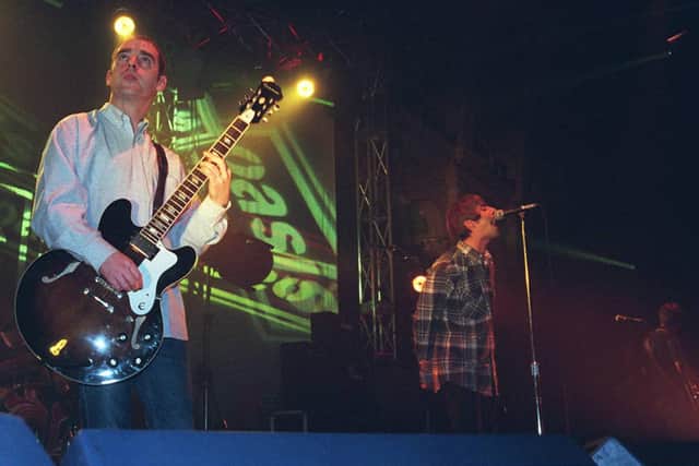Oasis on stage during their 1995 tour