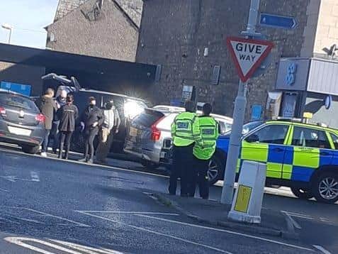 Police swooped on a black Range Rover outside the Co-Op in Carnforth yesterday  (Thursday, October 1) and arrested a man on suspicion of murder. Pic: Harry Yates
